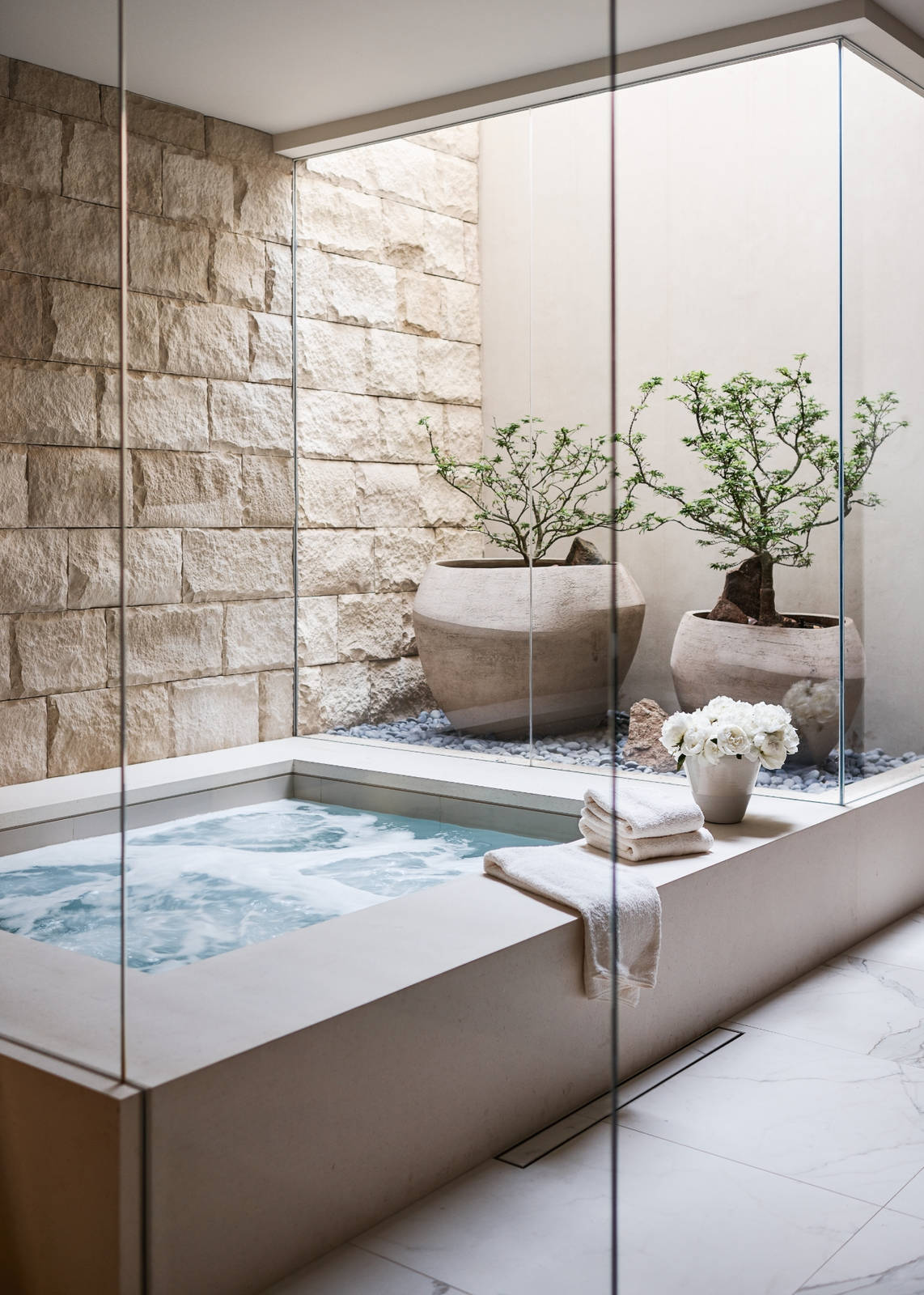 Spa area with two large trees in clay pots.