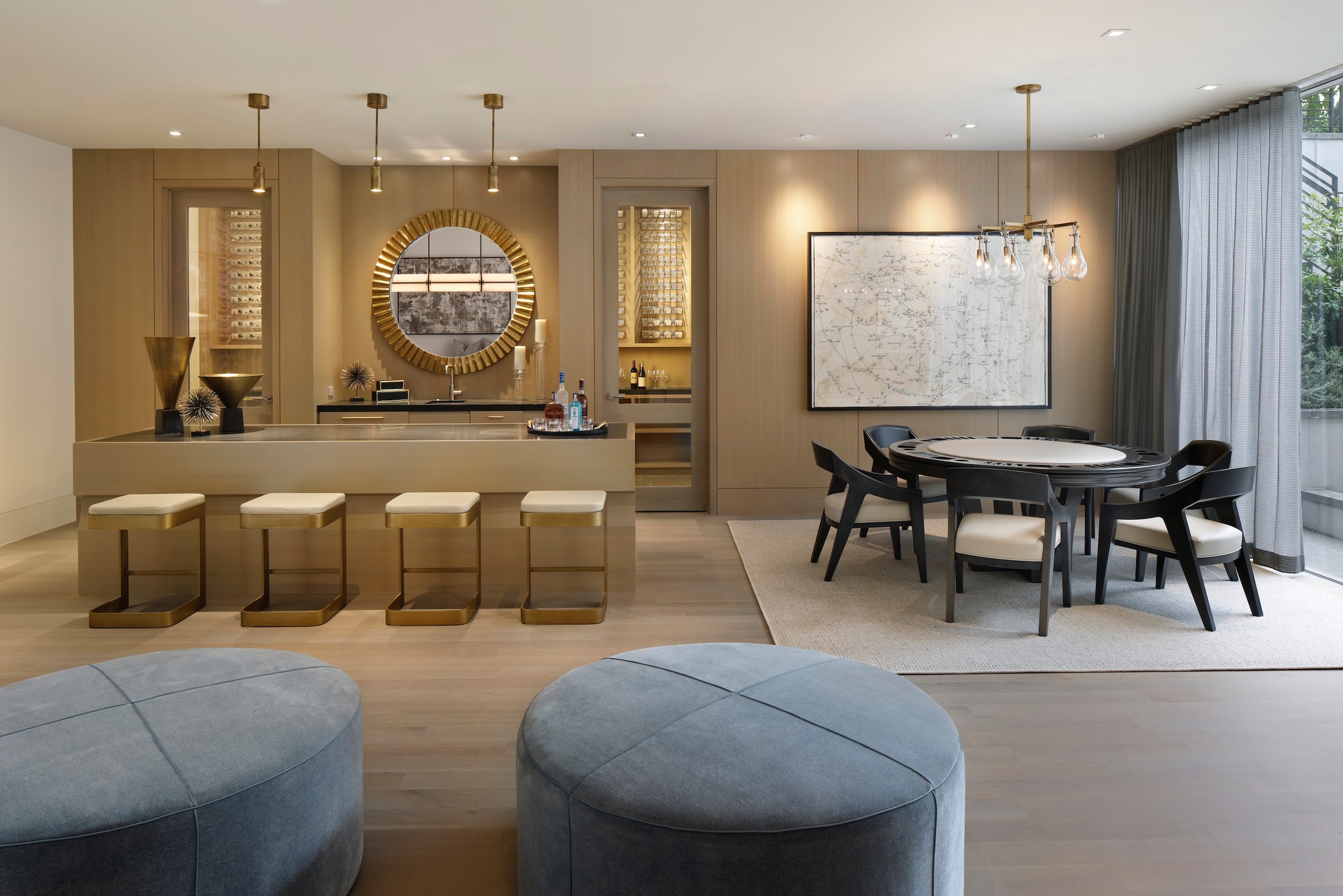 Bar area which includes four bar seats, and a seating area with black and gray detailed seats and tables.