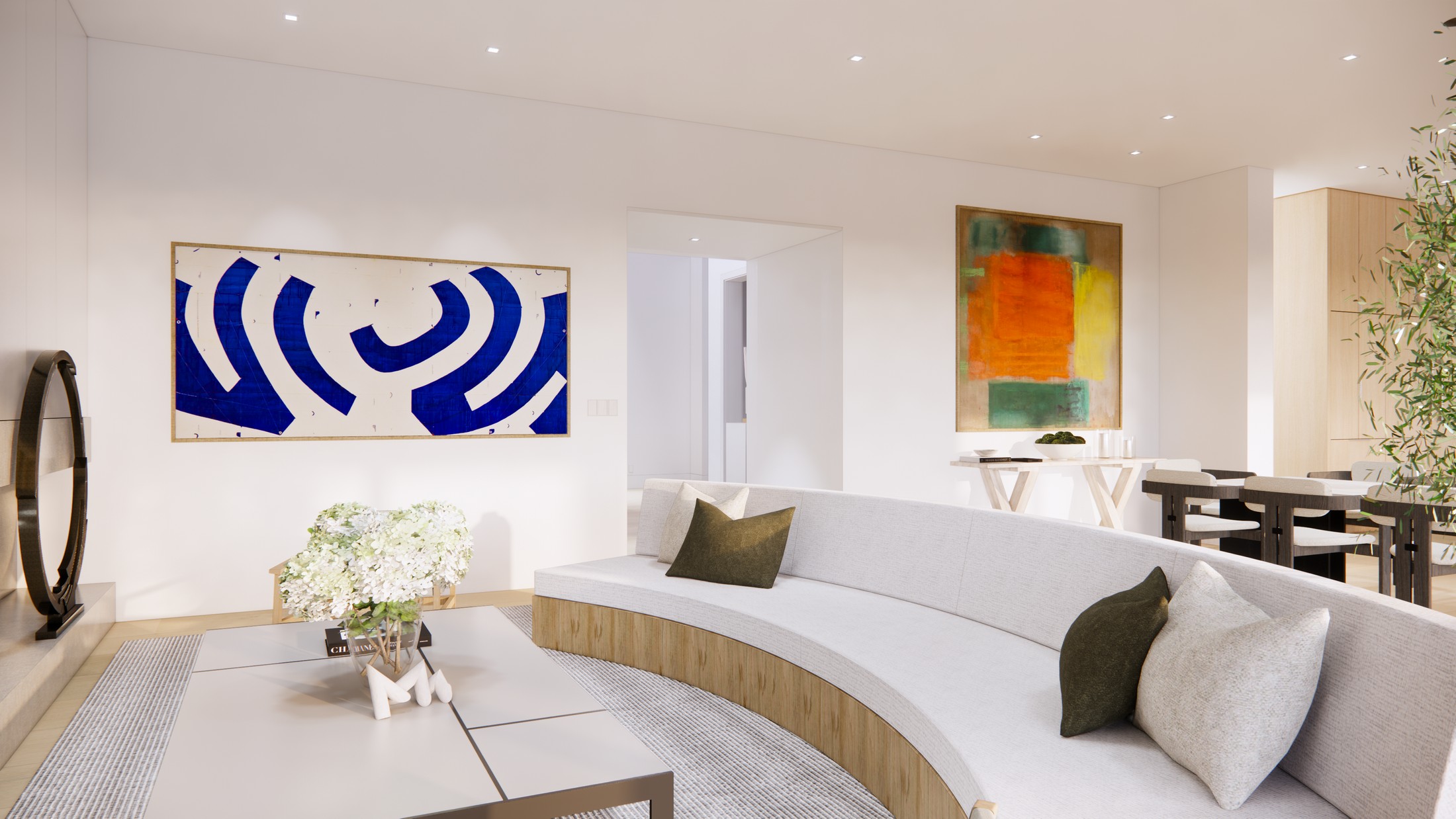 Rendered image of the living room, with a curved sofa, white and black table with flowers on it, and a large dining room table in the background. There is a blue and white abstract piece of art on the wall.
