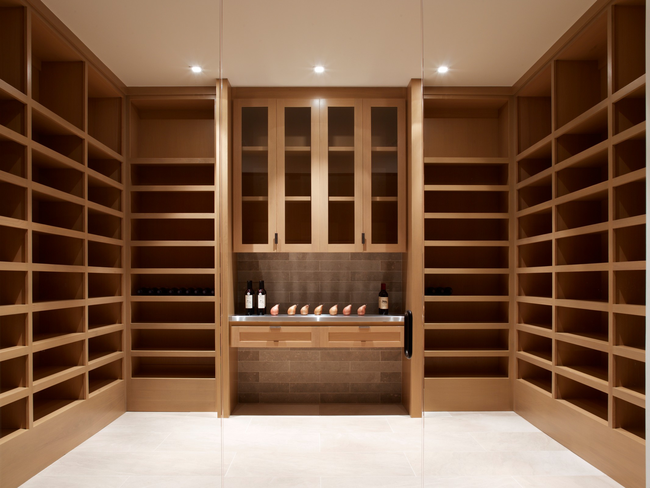 Wine room with wooden cabinets.